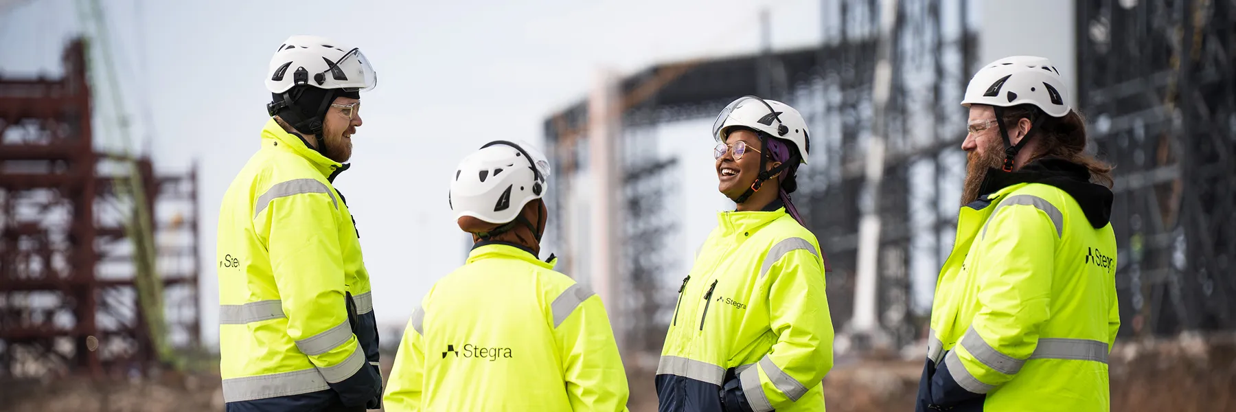 A team of Stegra operators in high-visibility jackets