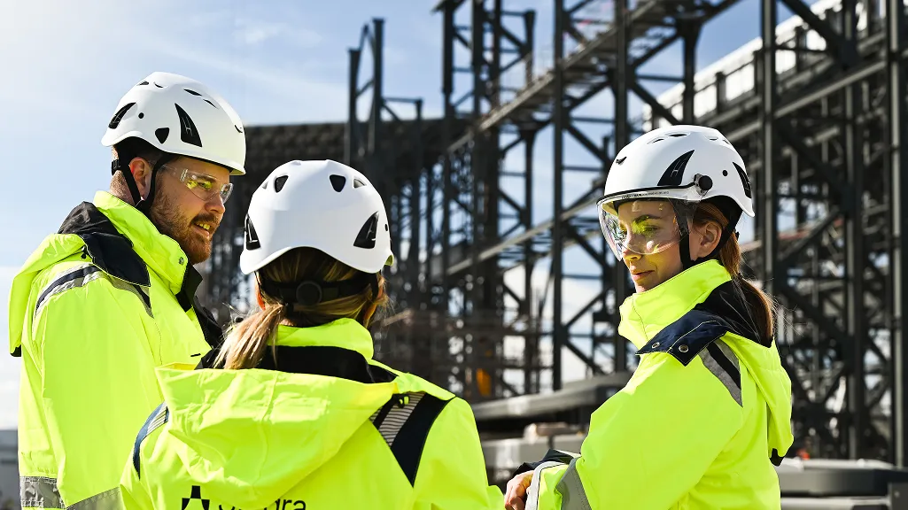 A Stegra Worker in Standing With a Safety Jacket On.