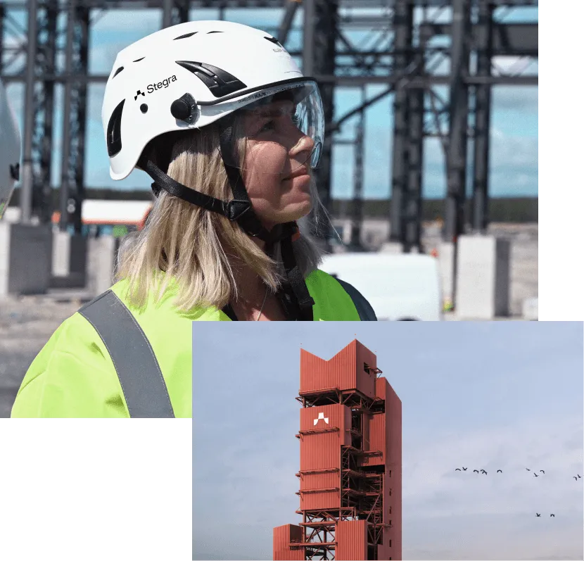 Woman standing outside wears a high-vis jacket and Stegra safety helmet with visor, and looks up to her left  Large red tower of a steel plant surrounded by dusk skies and thin cloud